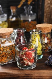 Photo of Many different herbs and flowers on wooden table