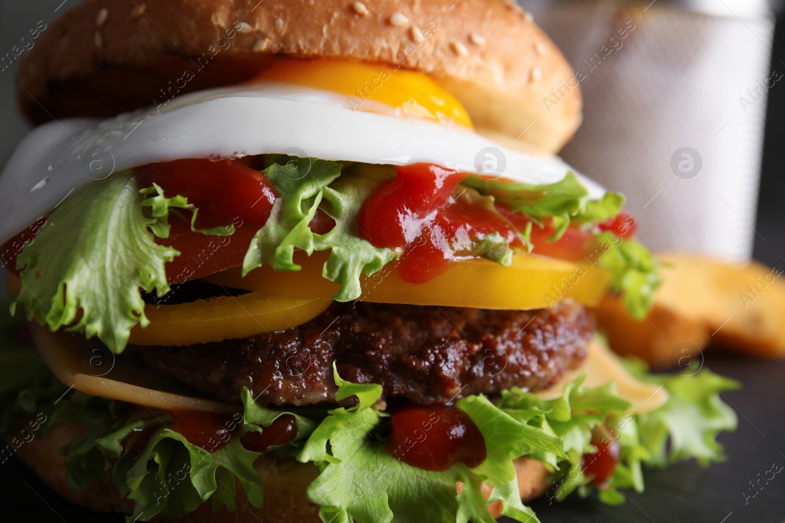 Photo of Closeup view of tasty burger with fried egg