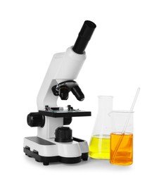 Laboratory glassware with colorful liquids and microscope isolated on white