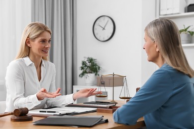 Senior woman having meeting with lawyer in office