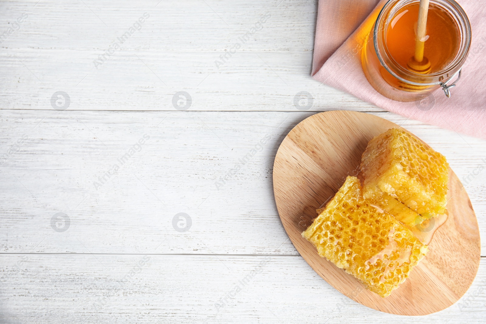 Photo of Flat lay composition with delicious honey on white wooden table. Space for text