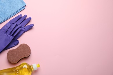 Flat lay composition with sponge and other cleaning supplies on pink background. Space for text