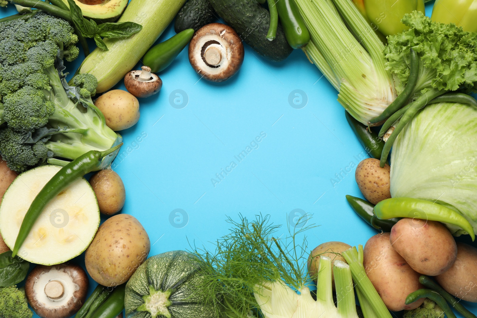 Photo of Frame of fresh vegetables on light blue background, flat lay. Space for text