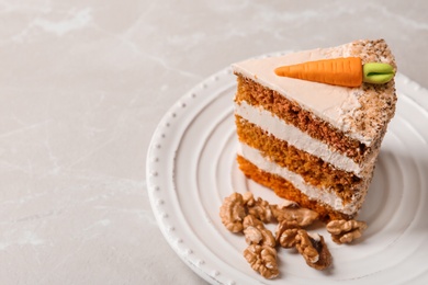 Photo of Piece of sweet carrot cake with delicious cream on light table, space for text