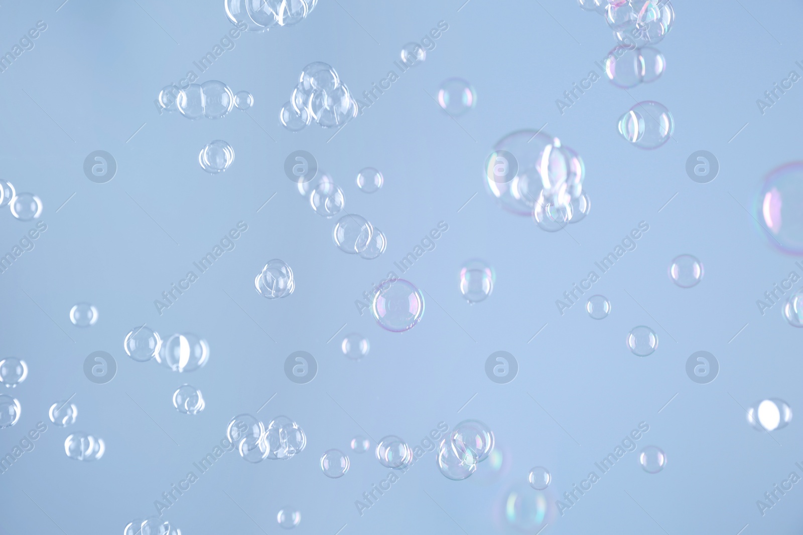 Photo of Beautiful transparent soap bubbles on light grey background
