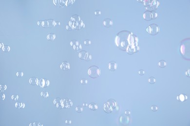 Photo of Beautiful transparent soap bubbles on light grey background