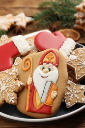 Photo of Tasty gingerbread cookies on table, closeup. St. Nicholas Day celebration