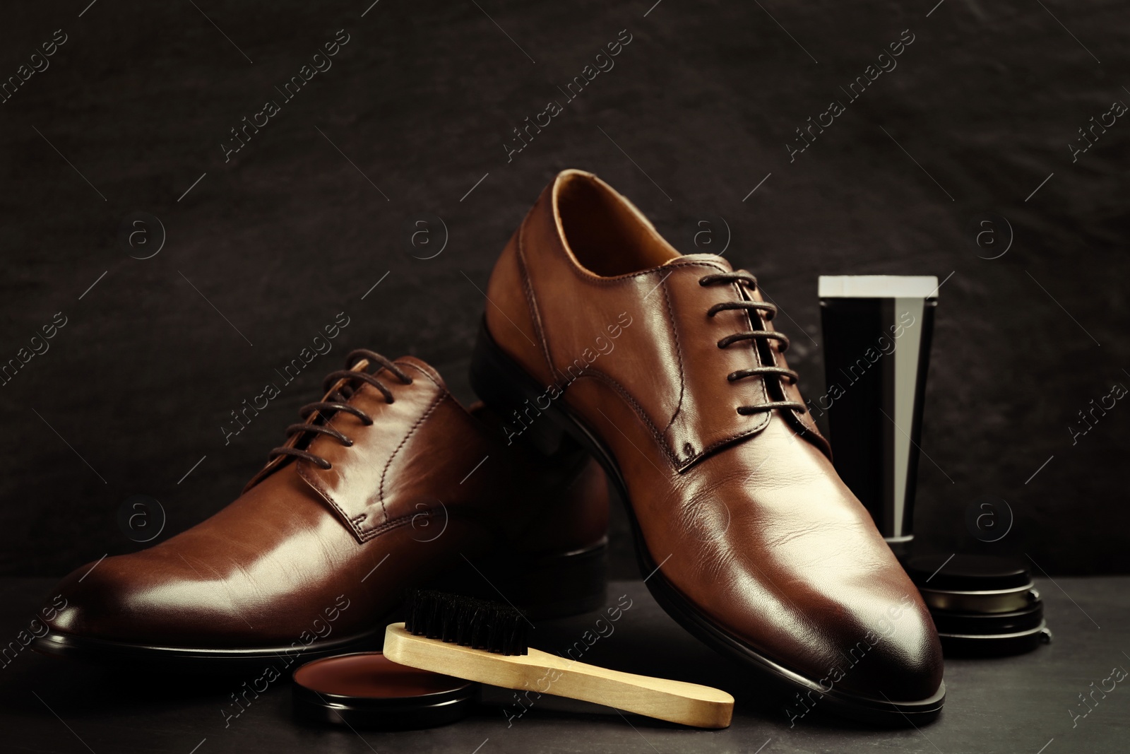 Image of Shoe care accessories and footwear on dark background