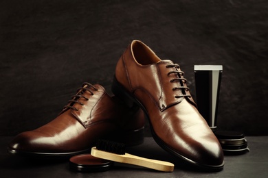 Shoe care accessories and footwear on dark background