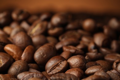 Photo of Heap of aromatic roasted coffee beans, closeup