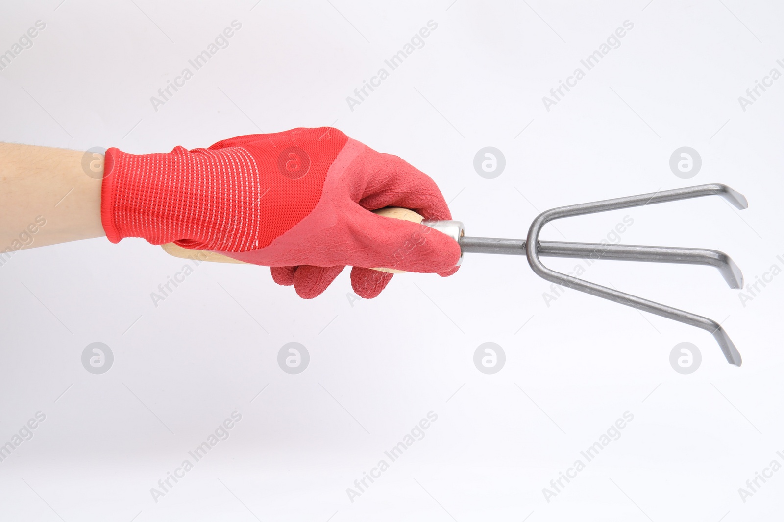 Photo of Woman in gardening glove holding rake on white background, closeup