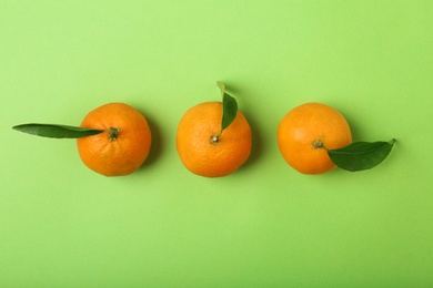 Photo of Composition with tangerines on color background, flat lay