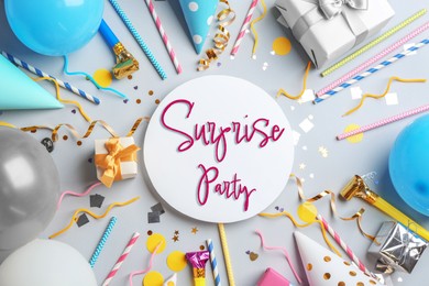 Image of Flat lay composition with different items for surprise party on light grey background