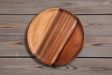 One plate on grey wooden table, top view