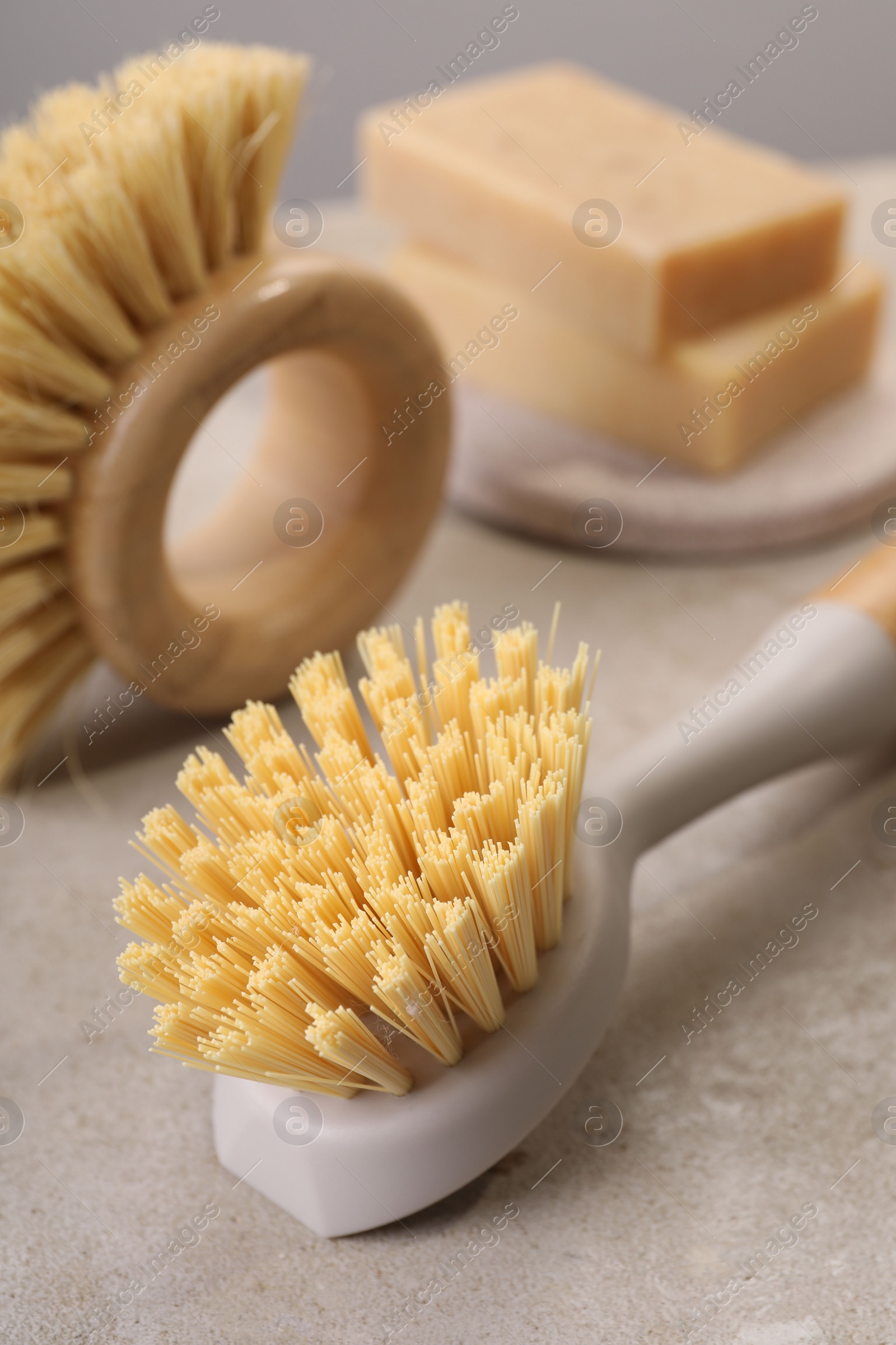 Photo of Cleaning brushes and soap bars on light grey table