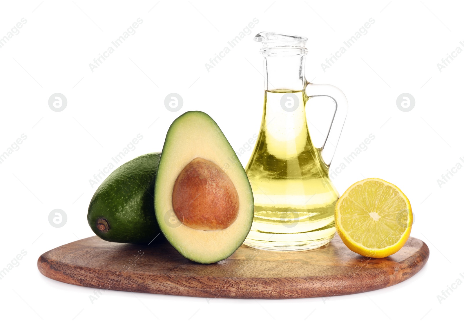 Photo of Cooking oil, lemon and fresh avocados isolated on white