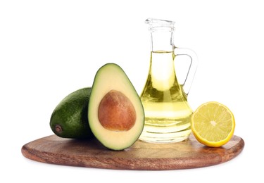 Photo of Cooking oil, lemon and fresh avocados isolated on white