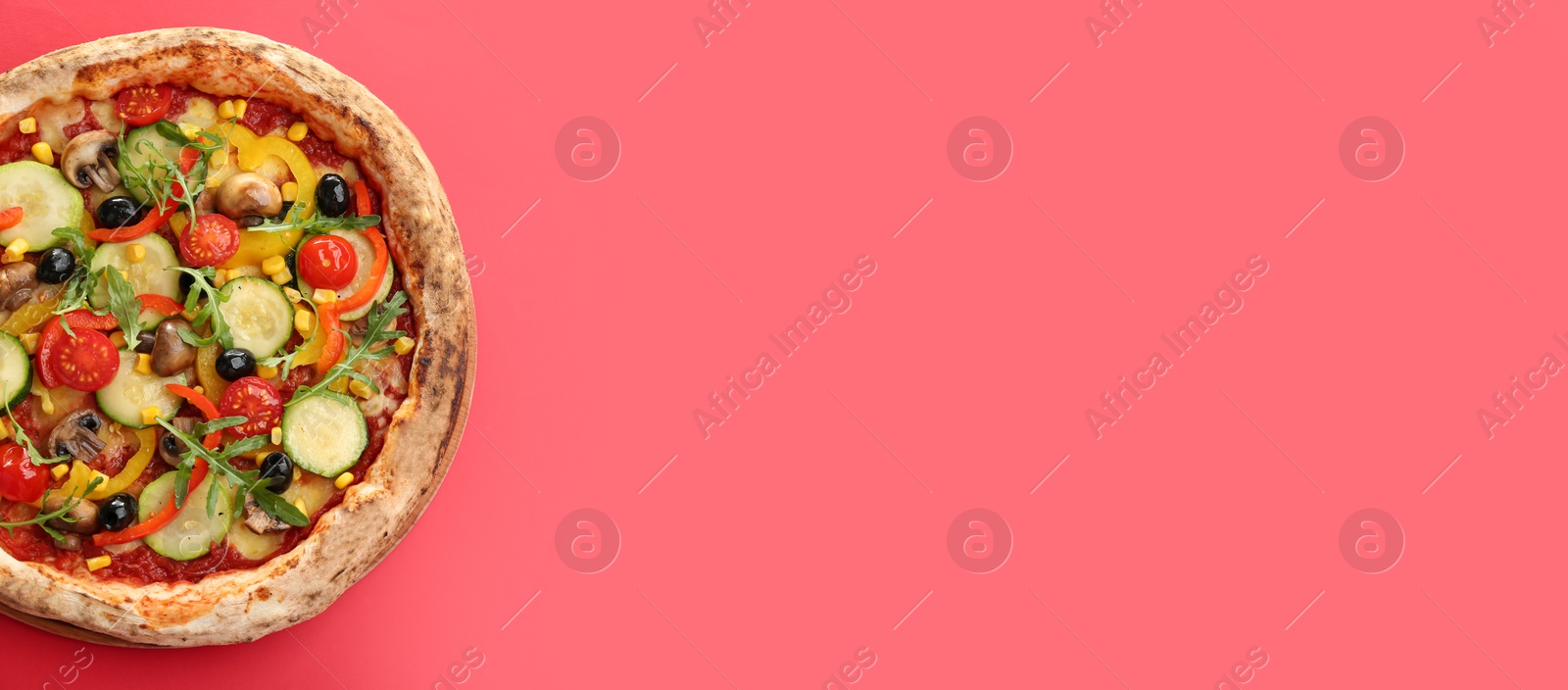 Photo of Delicious hot vegetable pizza on red background, top view. Space for text
