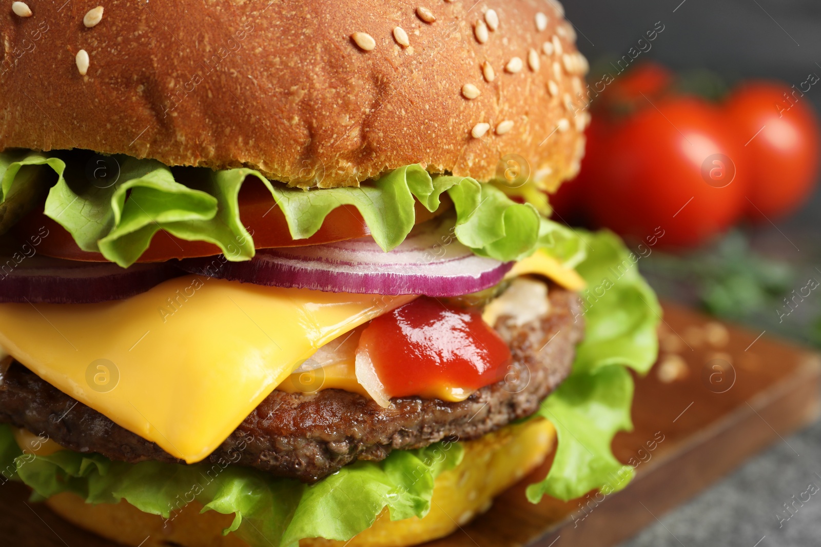 Photo of Delicious burger with beef patty and lettuce on table, closeup