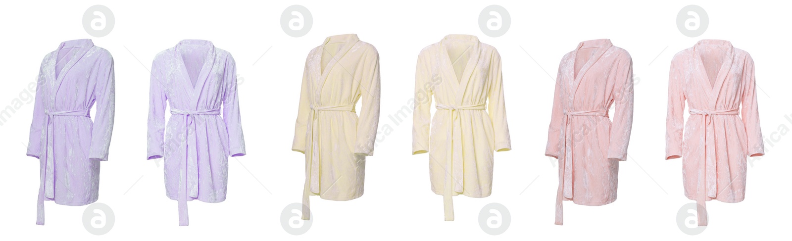 Image of Set of different color velour bathrobes on white background