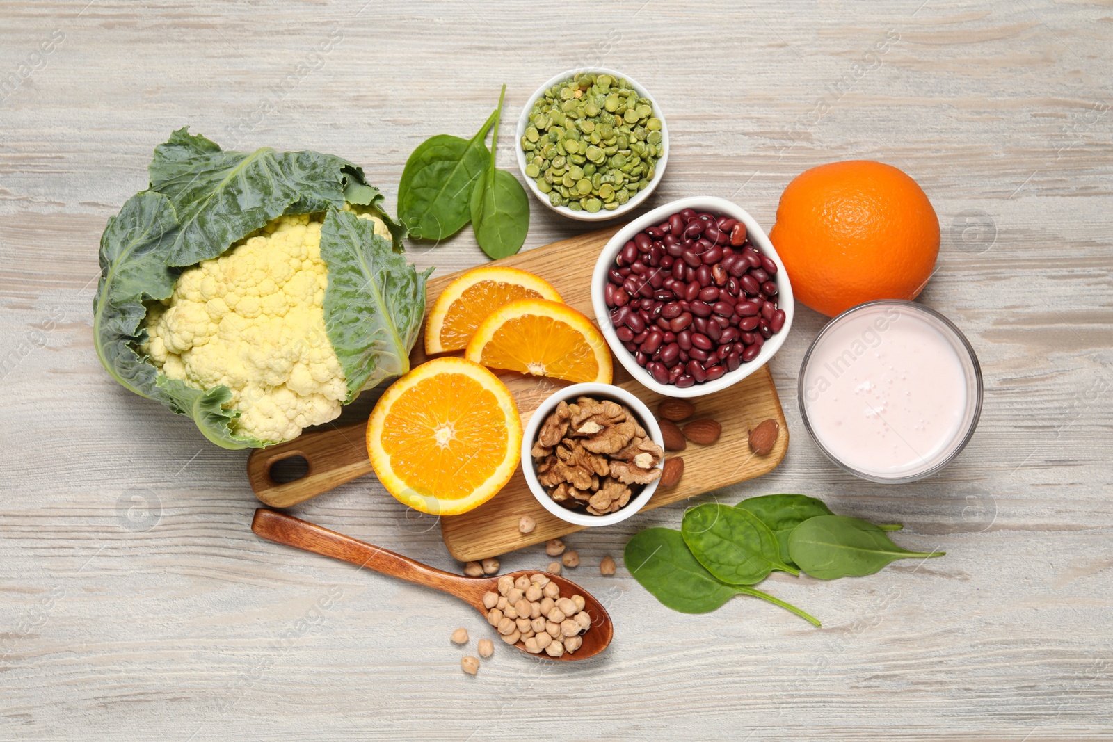 Photo of Set of natural food high in calcium on white wooden table, flat lay