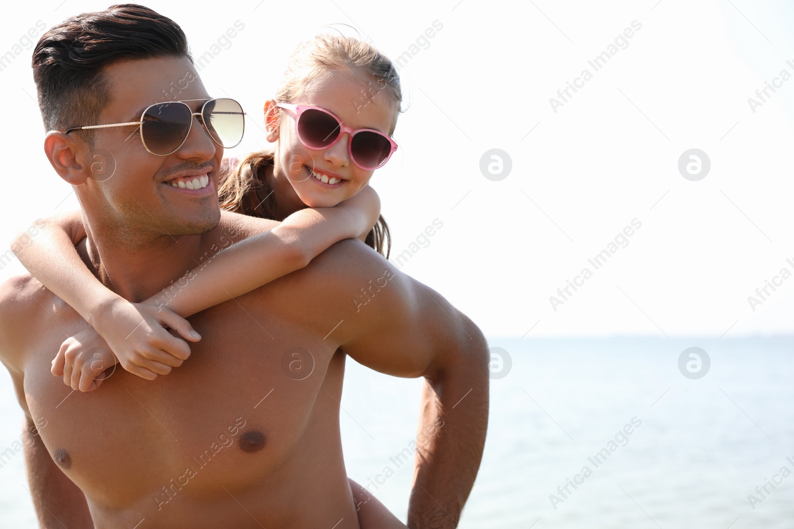 Photo of Father playing with daughter at beach. Family vacation