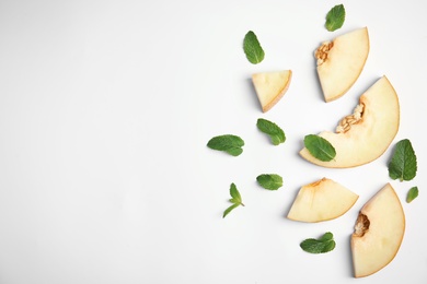 Flat lay composition with melon, mint leaves and space for text on white background