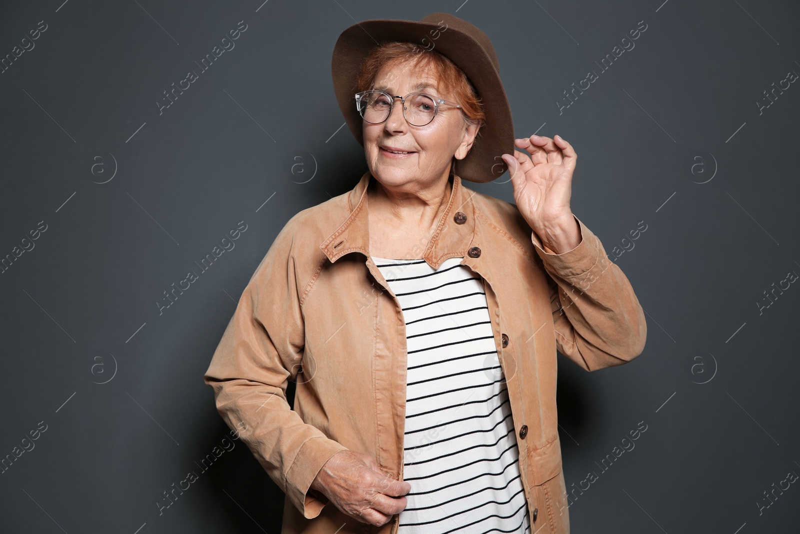 Photo of Portrait of elderly woman on grey background