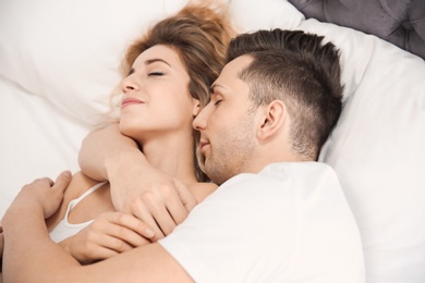 Photo of Lovely young couple sleeping in bed at home