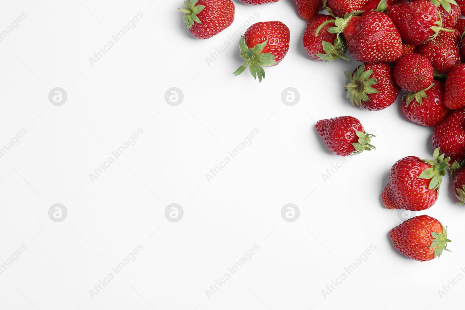 Photo of Tasty ripe strawberries on white background, flat lay. Space for text