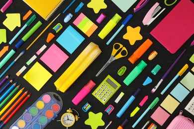 Photo of Flat lay composition with different school stationery on blackboard. Back to school