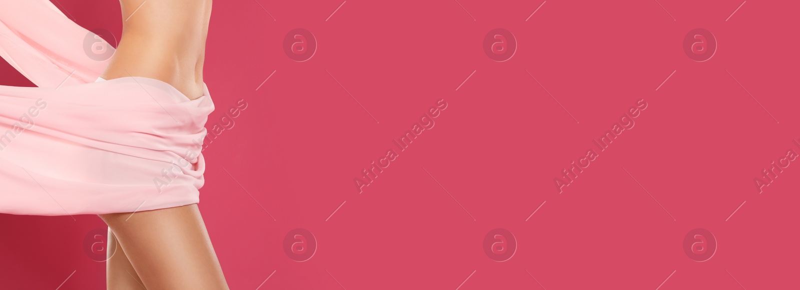 Image of Closeup view of slim young woman with fit body and silk fabric on color background, space for text. Banner design