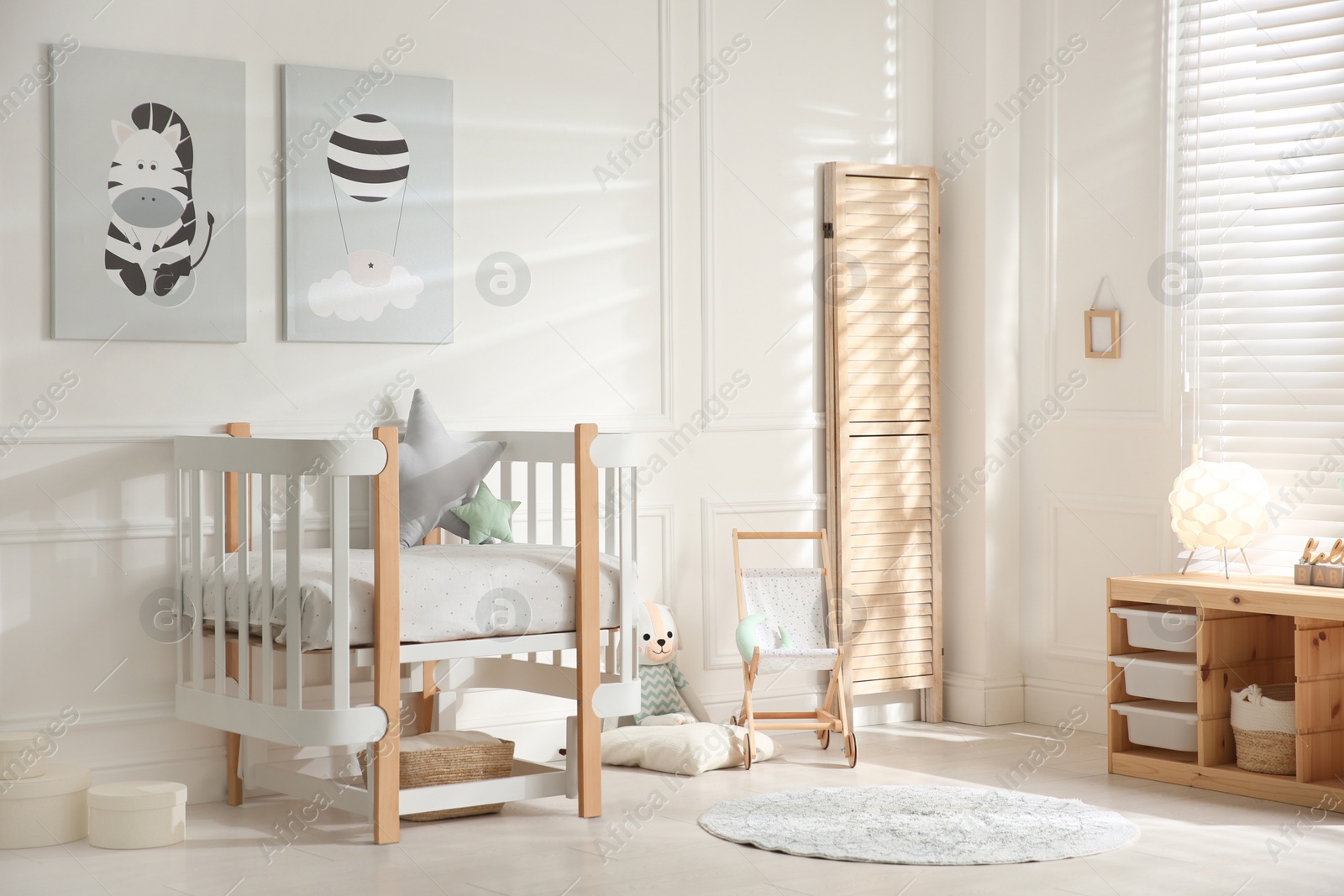 Photo of Baby room interior with stylish furniture and toys