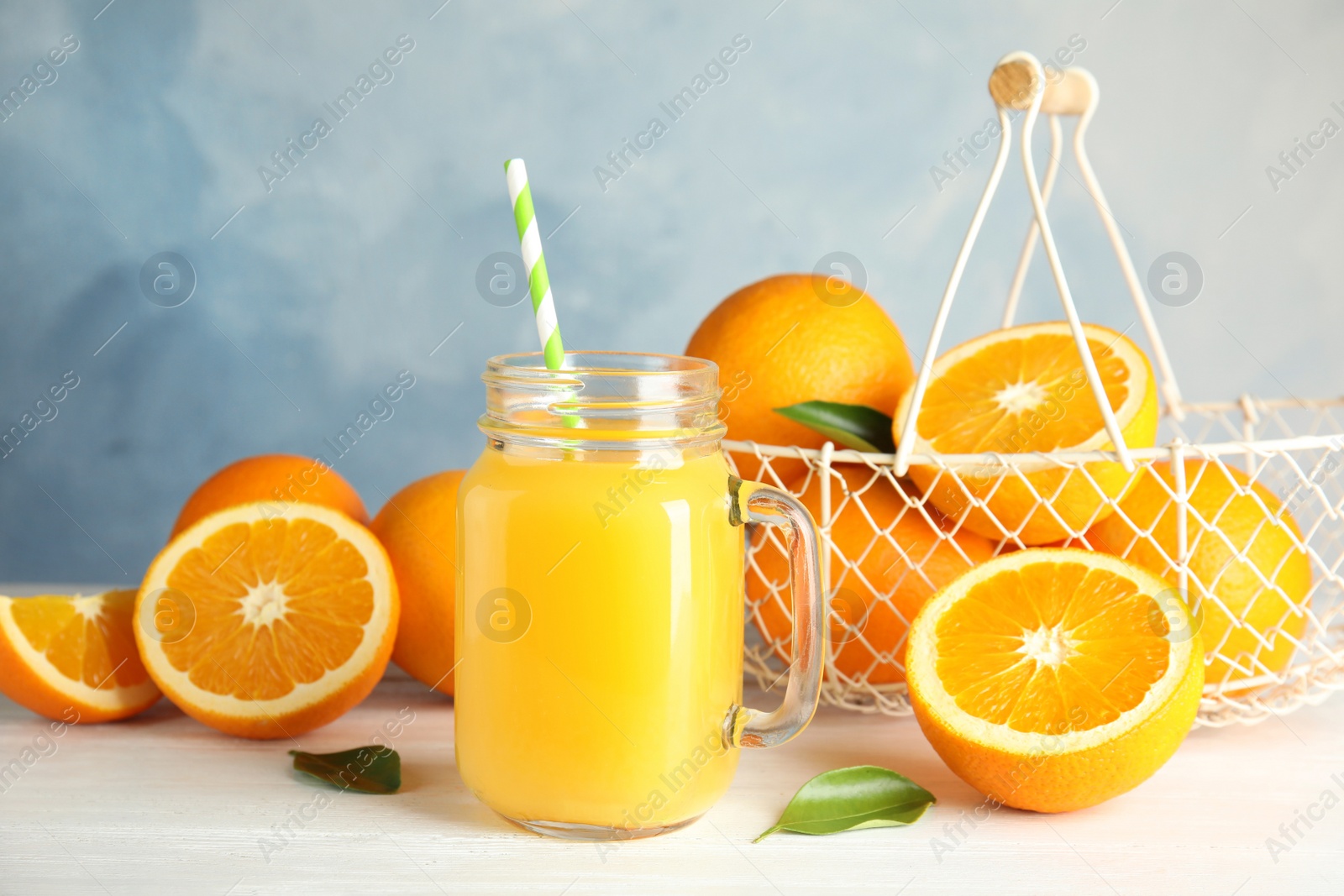 Photo of Composition with orange juice and fresh fruit on table