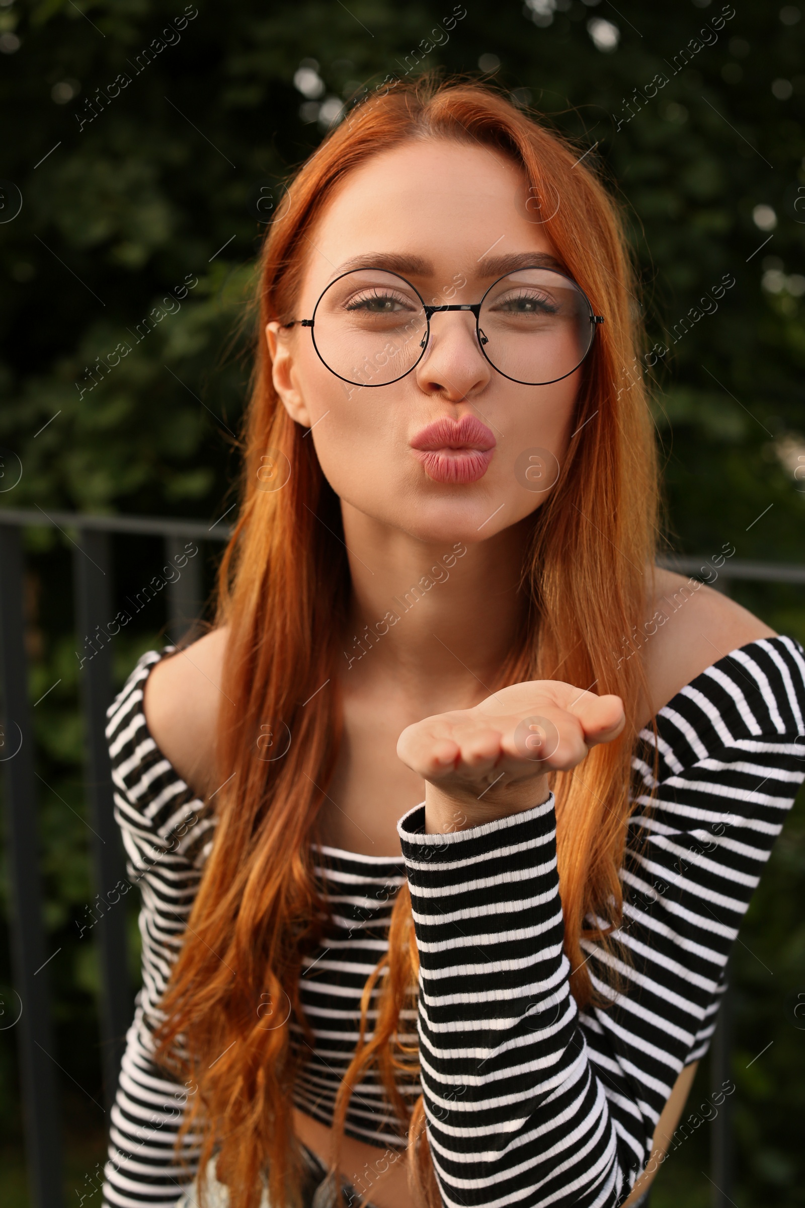 Photo of Portrait of beautiful woman in glasses outdoors