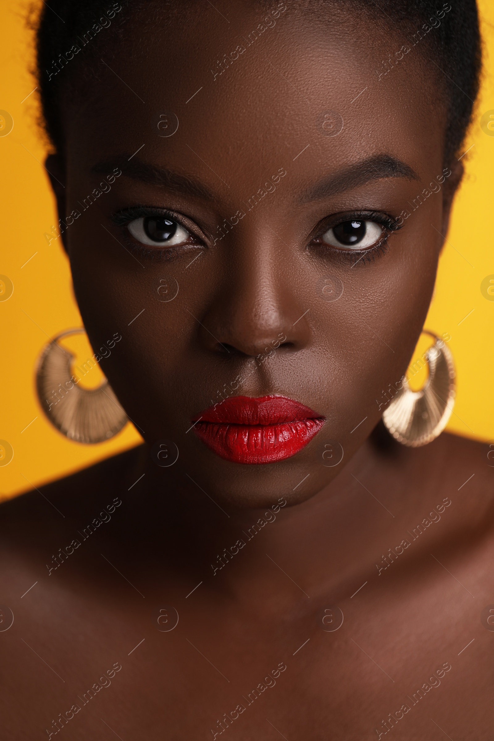 Photo of Fashionable portrait of beautiful woman on yellow background, closeup