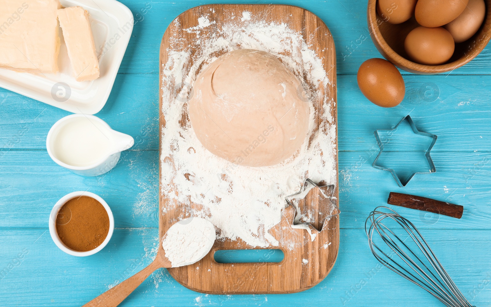 Photo of Flat lay composition with dough on light blue wooden table. Baking pie