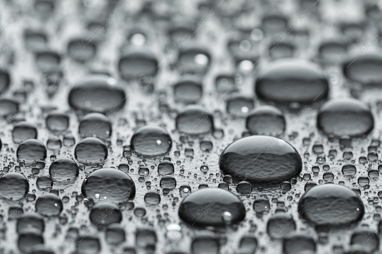 Photo of Water drops on grey background, closeup view