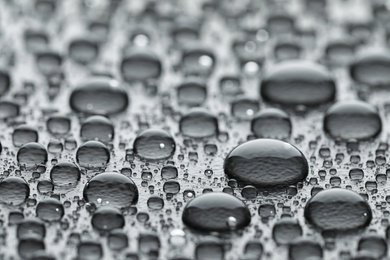 Water drops on grey background, closeup view