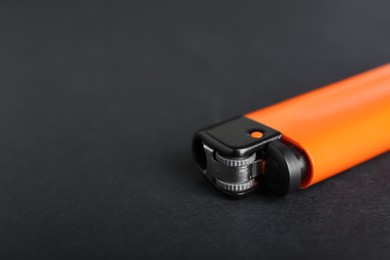 Photo of Stylish small pocket lighter on black background, closeup. Space for text