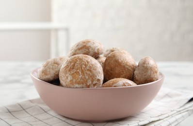 Photo of Tasty homemade gingerbread cookies in bowl on table