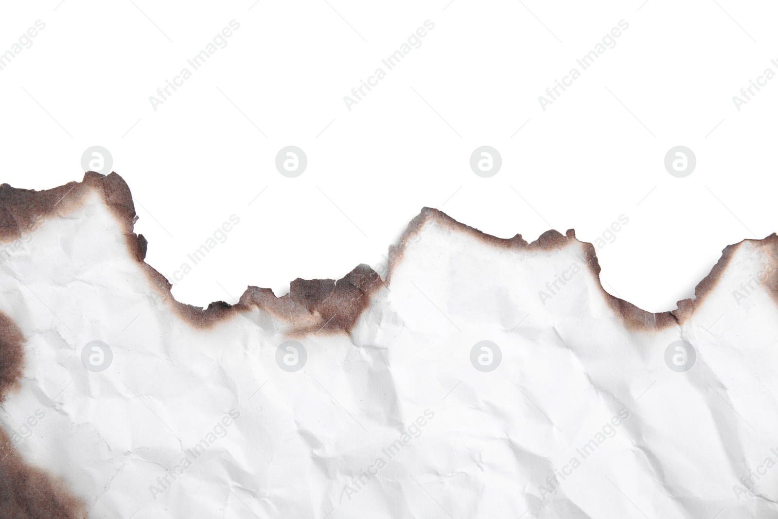 Photo of Piece of crumpled paper with dark burnt borders on white background, top view. Space for text