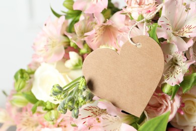 Photo of Happy Mother's Day. Beautiful flowers with blank heart shaped card on light background, closeup