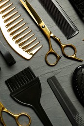 Photo of Hairdressing tools on grey textured background, flat lay