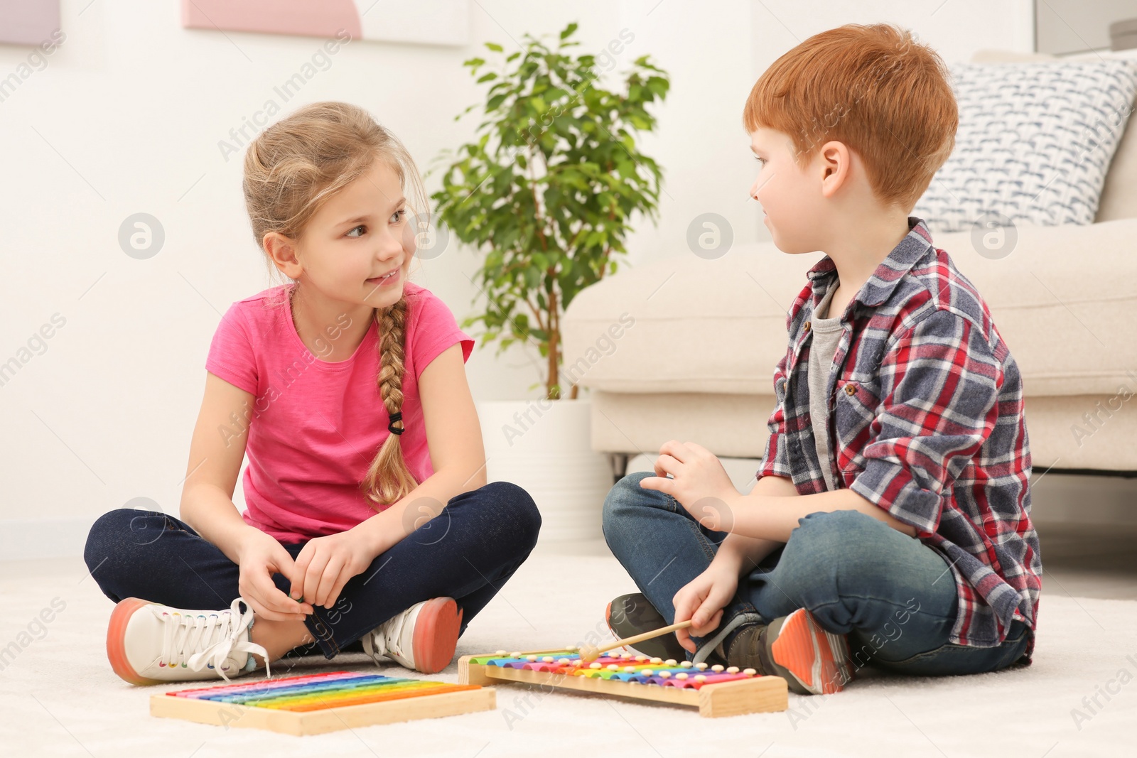 Photo of Children playing with different math game kits on floor in living room. Study mathematics with pleasure