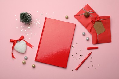 Red planner and festive decor on pink background, flat lay. New Year aims