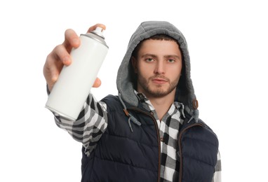 Handsome man holding can of spray paint on white background