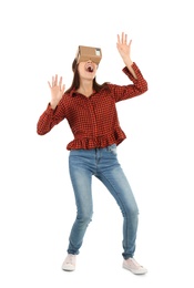 Young woman using cardboard virtual reality headset, isolated on white