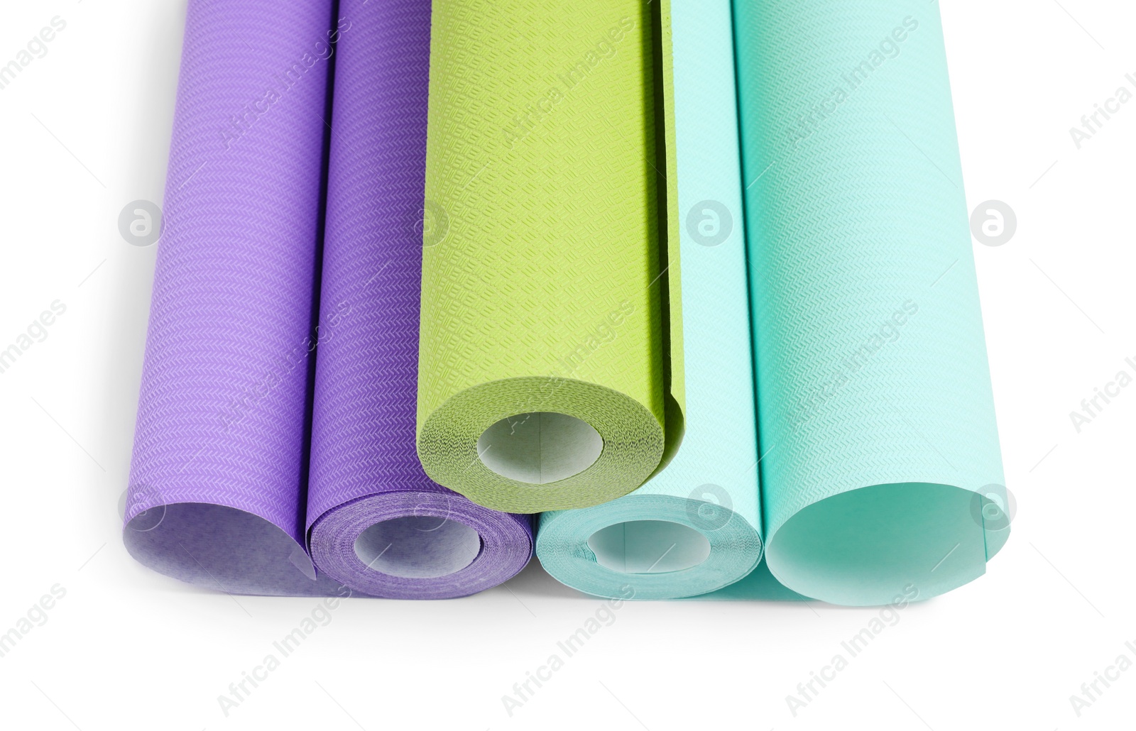 Photo of Three colorful wallpaper rolls isolated on white, above view