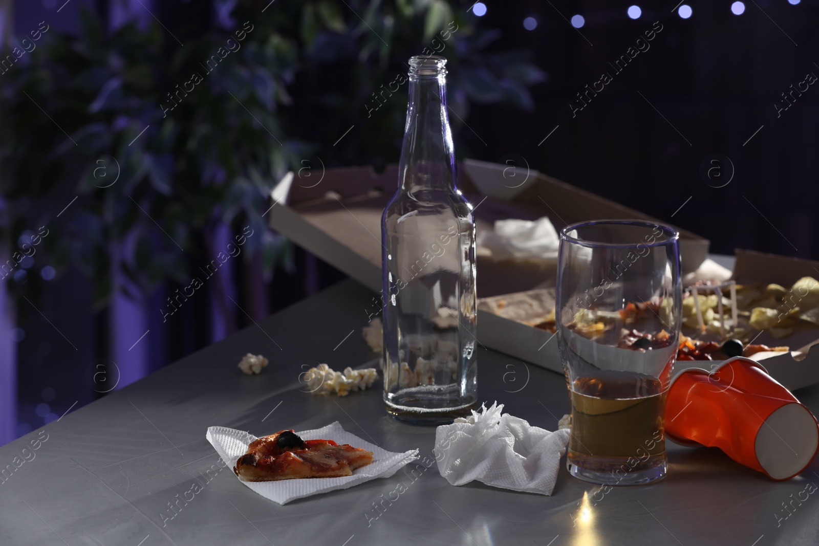 Photo of Messy table with beer and food leftovers indoors, space for text. After party chaos